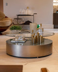 Modern living room with a round metallic coffee table and decorative items.